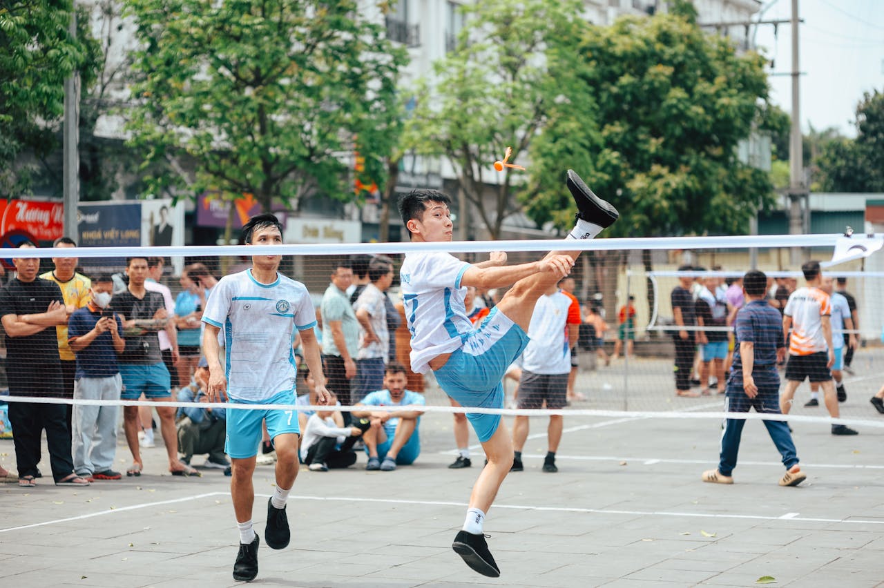 Exciting sepak takraw match in an urban park with energetic athletes demonstrating agility and skill.